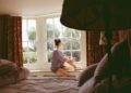 Woman sitting awake at night, caught in a cycle of worried thoughts